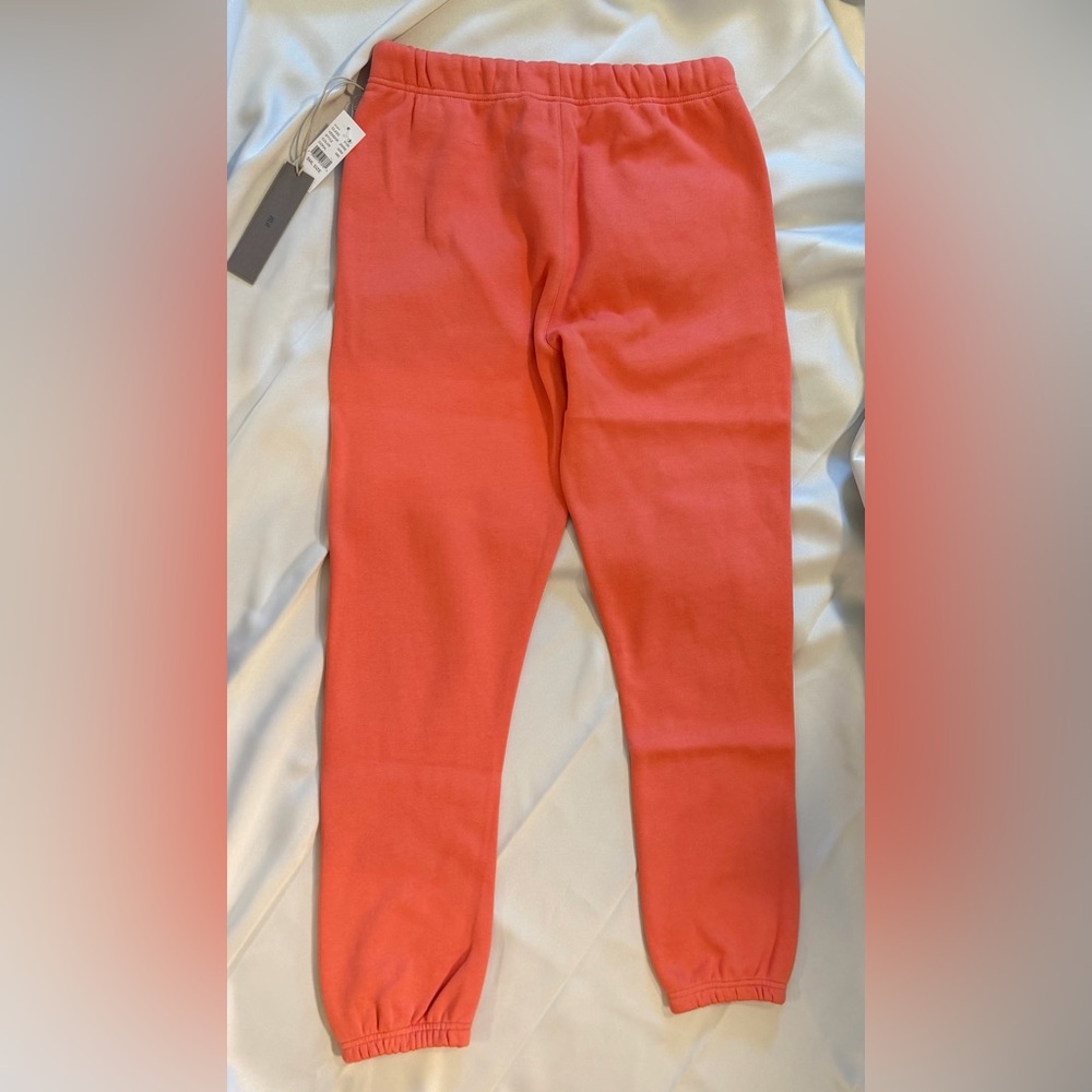 FEAR OF GOD ESSENTIALS - Tapered Logo Blend Jersey Sweatpants in Coral - Picture 11 of 11